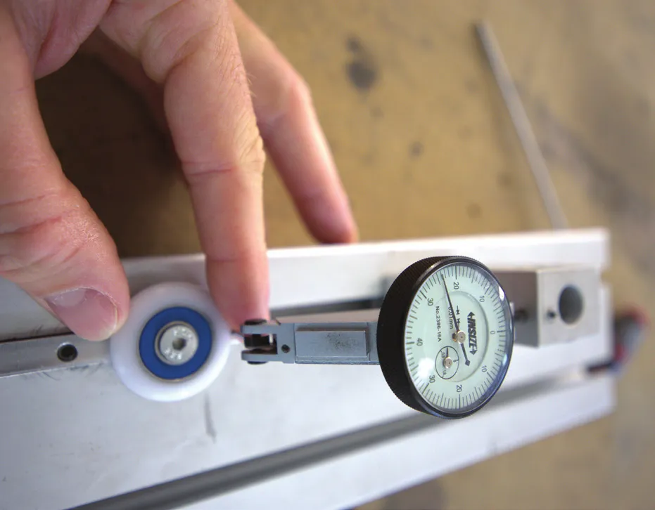 Dial gauge resting on a carriage during dimensional inspection