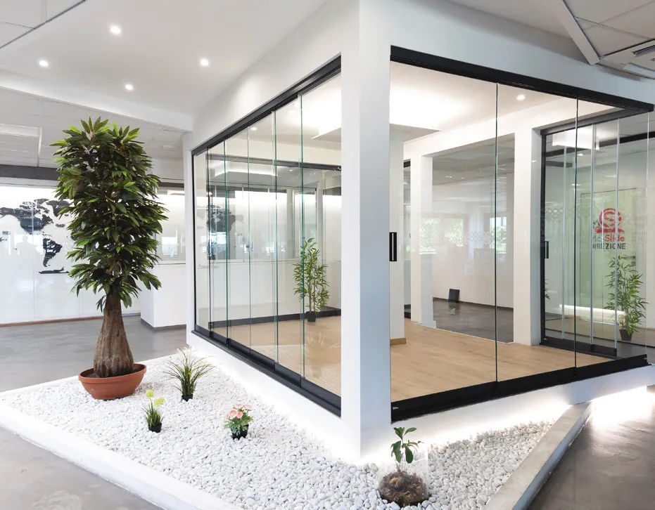 Glass enclosure with dark profiles in the MC Slide showroom