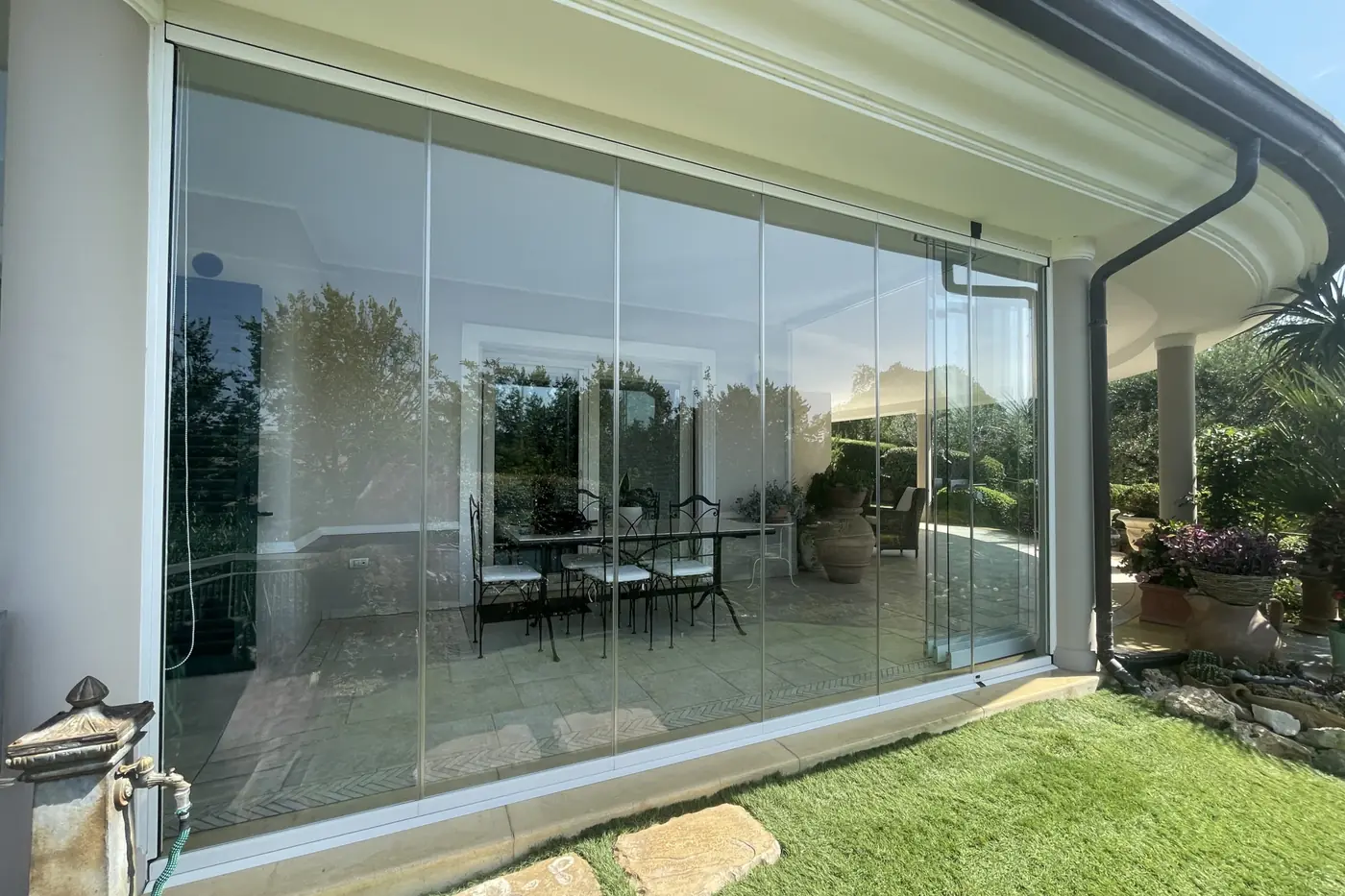 Colonnaded porch enclosed with Starglass glazing on a stone floor