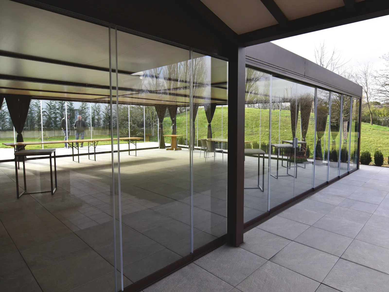 Inside the porch enclosed by Sliding Floor, with the park visible through the glass