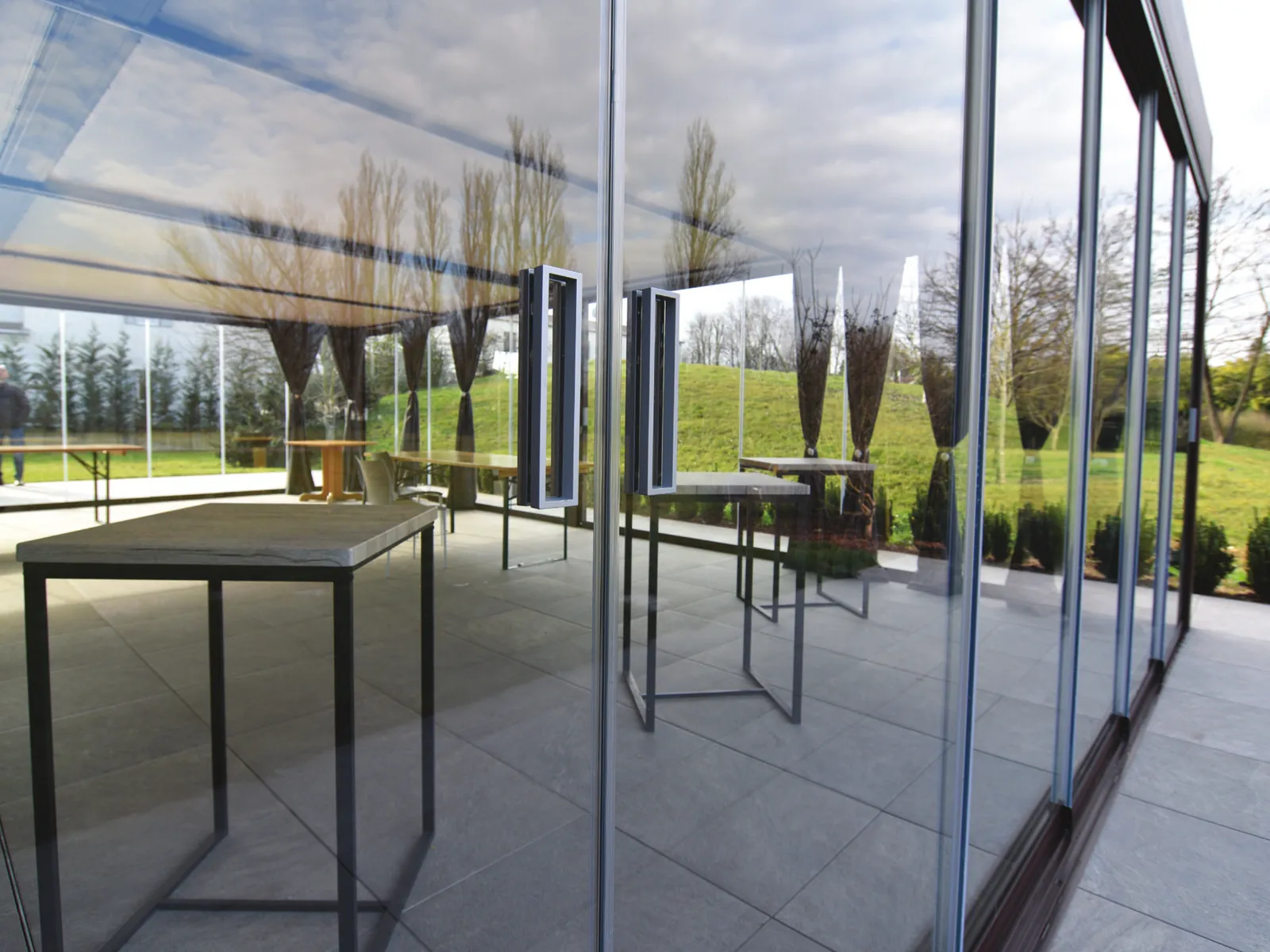 Sliding Floor panels stacked side by side, with the handles and the garden behind