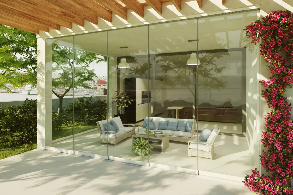 Veranda with sofas enclosed by Sliding Floor glazing under a pergola