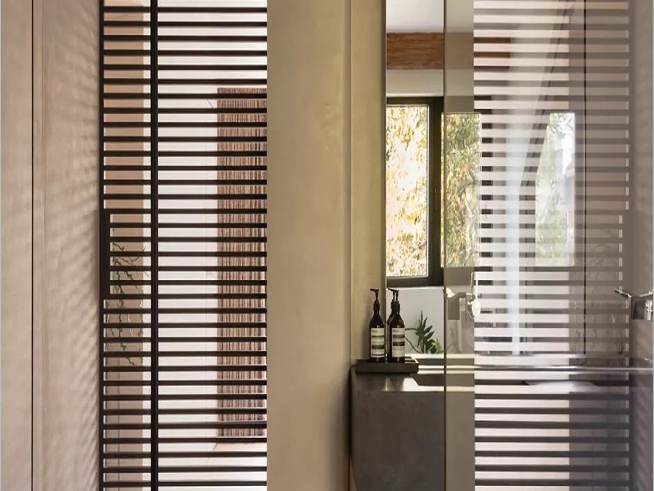 Frontal door beside a slatted wall