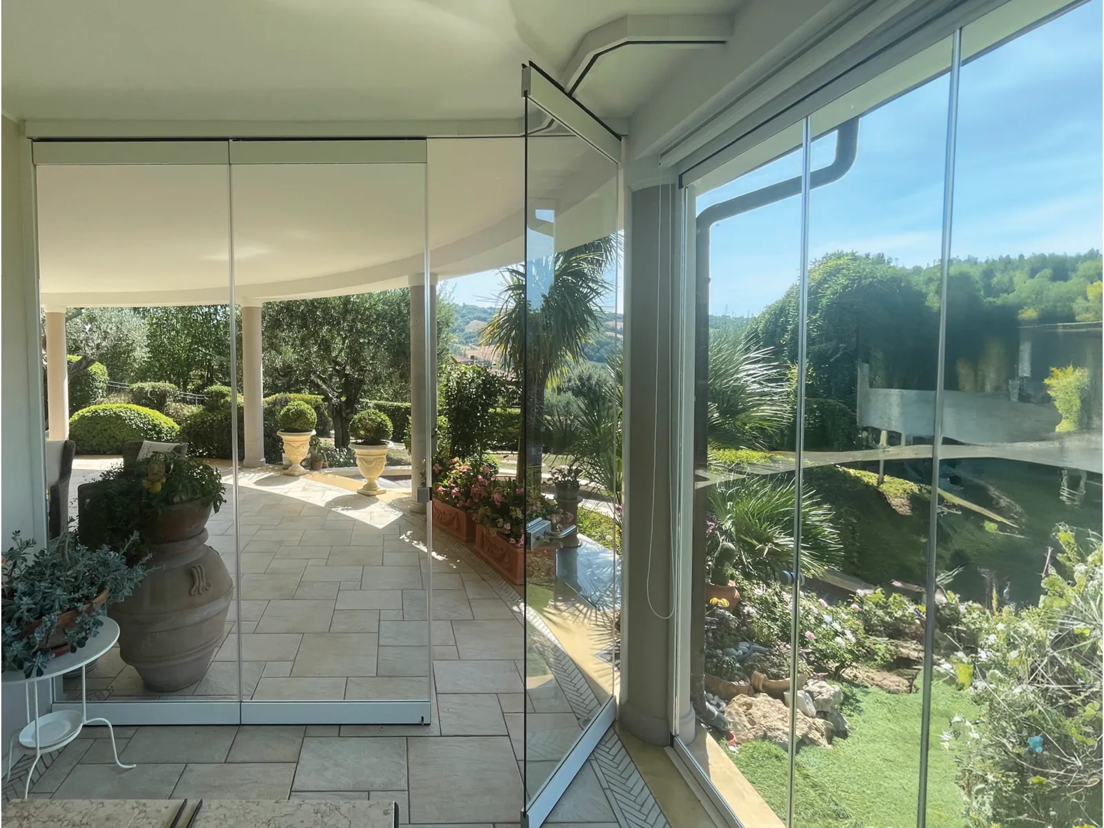 Veranda enclosed with Parking, with the garden beyond the glass